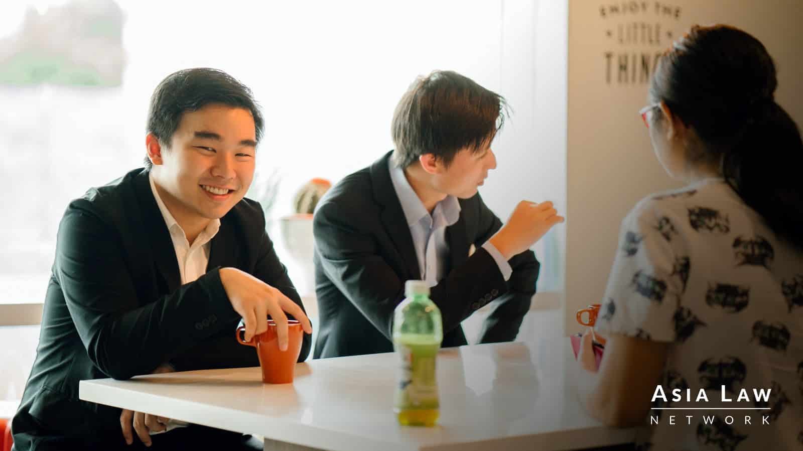 Photograph of a smiling lawyer in a black suit -- getting a second opinion on legal advice