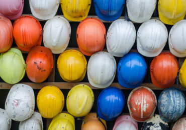 rows of construction helmets in various colours (Workplace Safety, Injuries, & The Law_Asia_Law_Network)