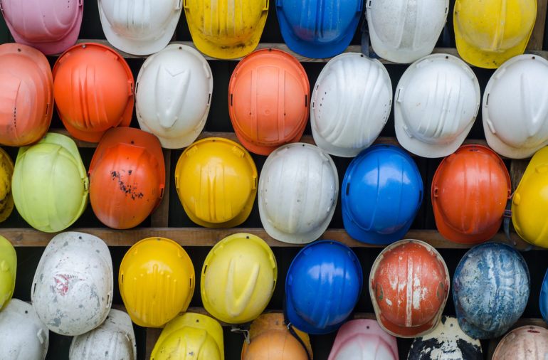 rows of construction helmets in various colours (Workplace Safety, Injuries, & The Law_Asia_Law_Network)