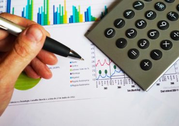 paper charts with a pen and calculator (What's next after the end of a startup? (Case study - Living the Link)_Asia_Law_Network)