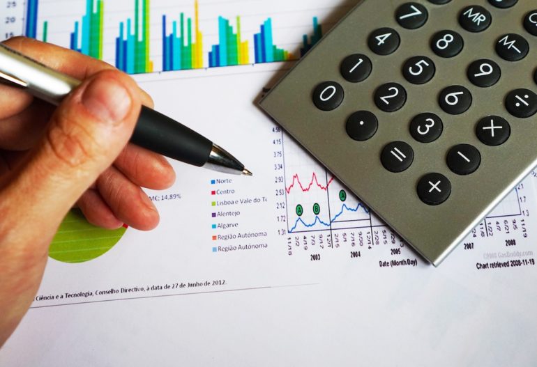 paper charts with a pen and calculator (What's next after the end of a startup? (Case study - Living the Link)_Asia_Law_Network)