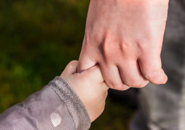 a child hand holding an adult hand (custody_care_control_children_divorce_asia_law_network)