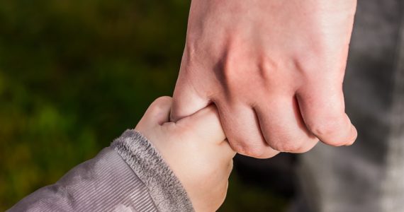 a child hand holding an adult hand (custody_care_control_children_divorce_asia_law_network)