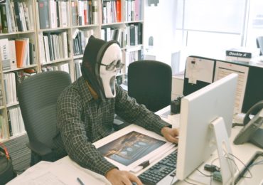 man wearing a white mask using the computer with a bookcase in the background white_collar_crime_asia_law_network