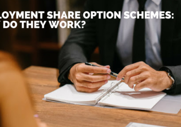 Man holding pen with a notebook Employment Share Option Schemes_ How do they work_